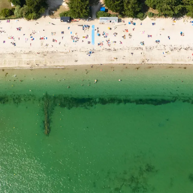 Aerial view of Kerleven beach in summer with people on the beach and turquoise water